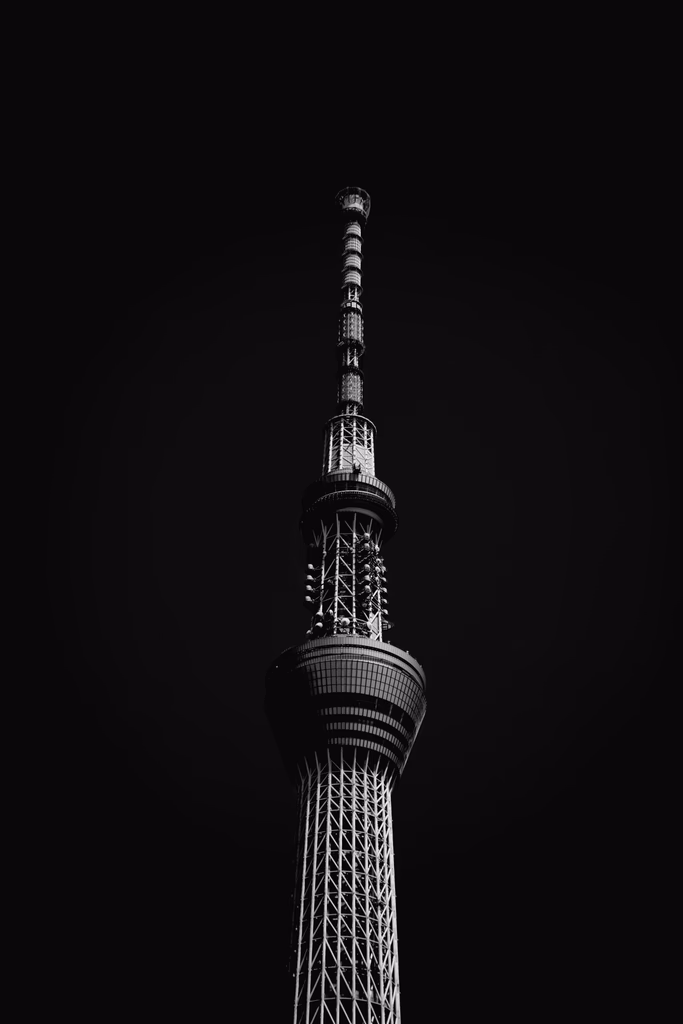 A tall modern tower against a dark sky.